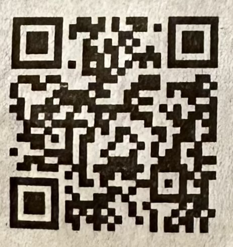 A qr code on a white surfaceDescription automatically generated